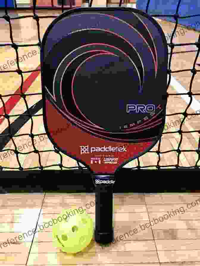 A Close Up Of A Pickleball Paddle, Showcasing Its Lightweight Design And Perforated Surface. PICKLEBALL FOR BEGINNERS: Essential Guide On Pickle Ball For Beginners